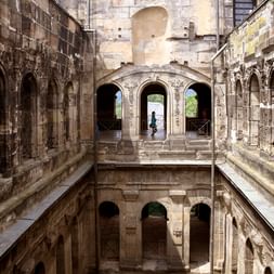 Innenansicht der Porta Nigra in Trier mit mehrstöckiger römischer Steinarchitektur, Rundbögen und verwitterten Sandsteinmauern.