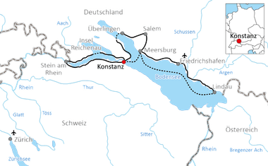 Karte mit Radweg rund um den Bodensee mit markiertem Konstanz. Route verläuft durch Deutschland, Schweiz und Österreich mit durchgezogenen und gestrichelten Linien.
